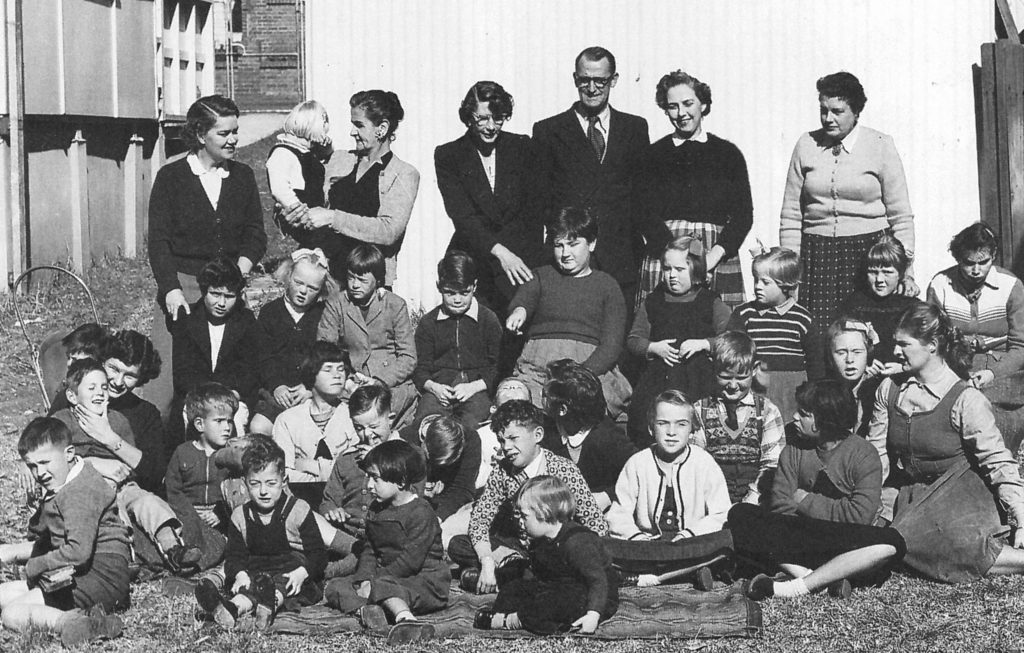 Kids with parents on Flora Street 1950