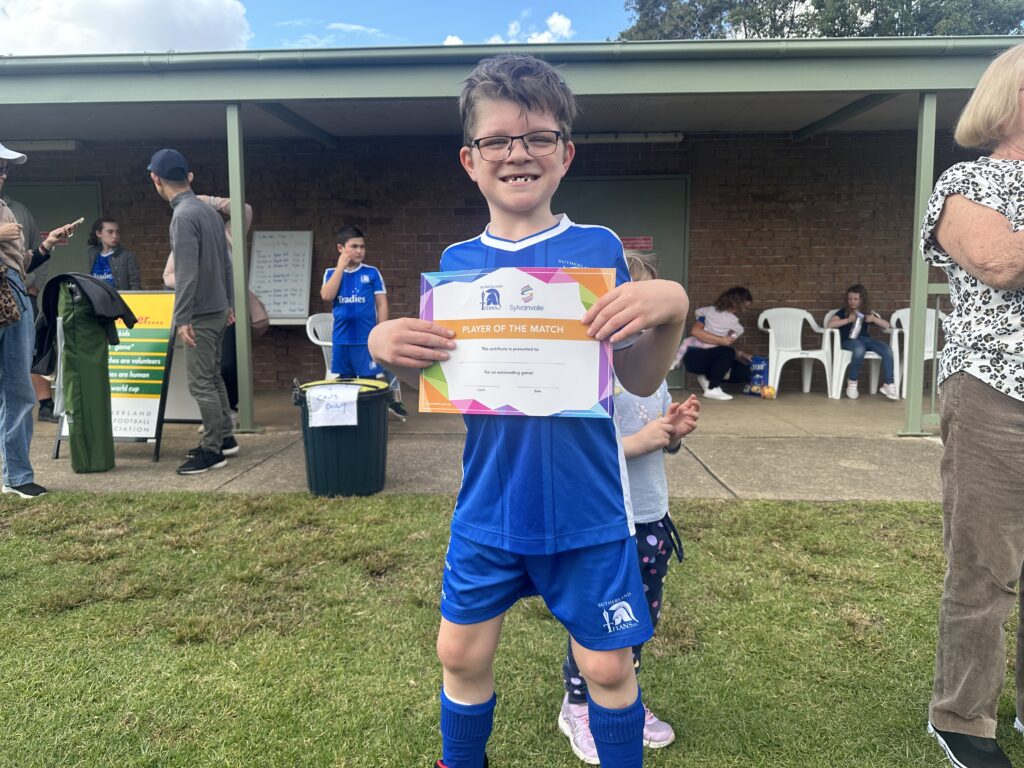 Titans player holding Player of the Match certificate