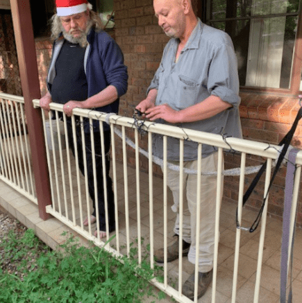 Frank and Paul decorate their unit ready for Christmas. 2022 - Katoomba