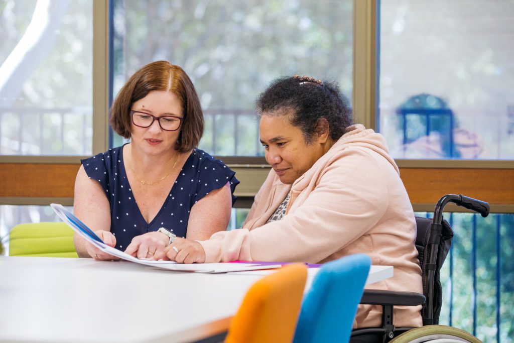 Sylvanvale employee showing participant a document