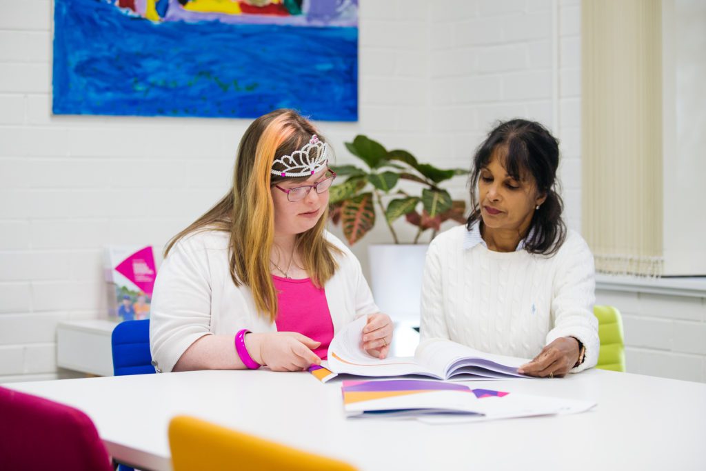 Support worker helping participant read document