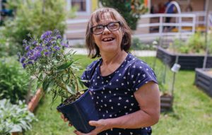 Garden house lady holding plant