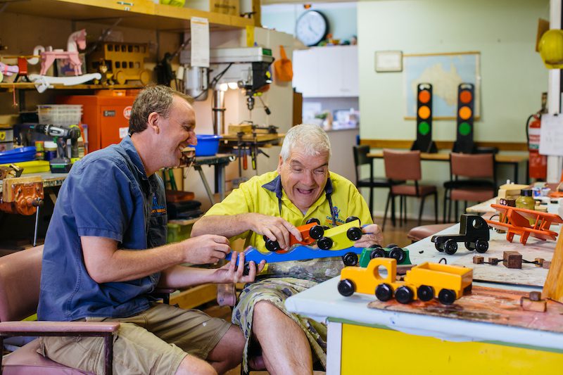 Local business awards Participant and support worker making toys