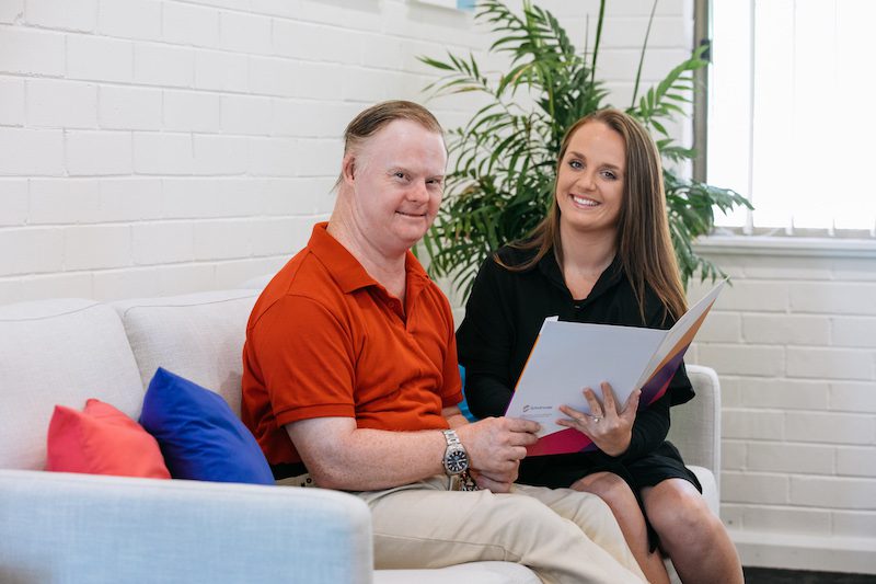 Participant and support worker reading over document together